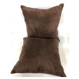 Two matching brown plush throw pillows