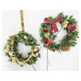 Two lighted wreaths with hangers
