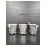Three galvanized planters in a chicken wire holder