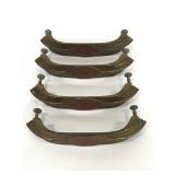 Four gold and red metal drawer pulls