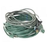 Pair of green outdoor extension cords
