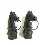 Two large cast iron horse heads