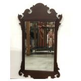 Ornate wooden framed wall mirror