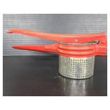 Vintage red handle potato ricer