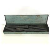 Metal tool box of assorted chisels
