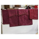 Purple ornate curtain panels and table linnens