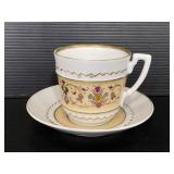 Gold trimmed white and floral tea cup and saucer