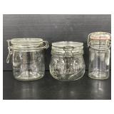 Three glass metal locking jars