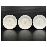 Trio of white ceramic embossed saucers