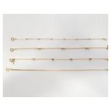 Four petite gold tone bracelets