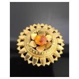 Gold toned metal brooch