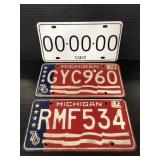 Three vintage license plates