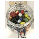 Glass jar of assorted vintage marbles