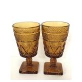 Two matching cut amber glass goblets