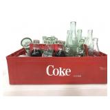 Collection of Coca-Cola items in crate