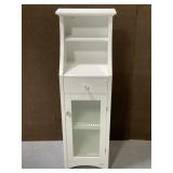 White wood linen cabinet with glass door