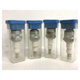 Four Autolite spark plugs