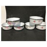 Two sets of enamel floral nesting bowls