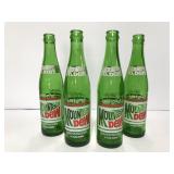 Four vintage Mountain Dew green bottles