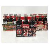 Three commerative Coca Cola six packs