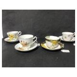 Four yellow floral tea cups & saucers