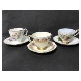 Three fruit themed tea cups and saucers