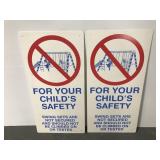 Two plastic child safety swing set signs