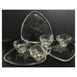 Three snowflake glass snack trays with 4 cups