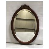 Wood framed oval wall mirror