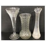 Three assorted clear glass flower vases