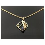 Ornate gold tone leaf pendant necklace