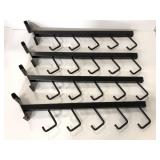 Four black metal slotted wall hooks