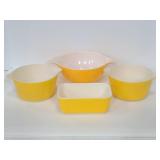 Four yellow vintage pyrex dishes