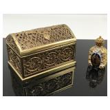 Petit ornate glass perfume bottle in metal chest