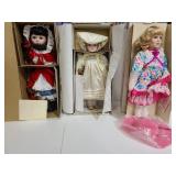 Three porcelain dolls with boxes