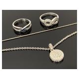 Two silver tone necklaces & two rings
