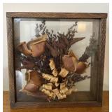 Dried flower arrangement in wood frame