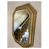 Ornate gold toned wall mirror w/ beveled edges