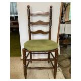 Antique chair with green cushion