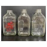Three vintage 64oz glass juice bottles