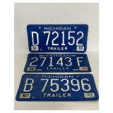 Three vintage Michigan license plates