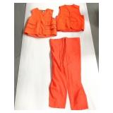 Two bright orange vests and water pants
