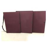 Three large plum colored artist portfolio holders