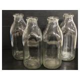Four vintage 1 qt glass milk bottles