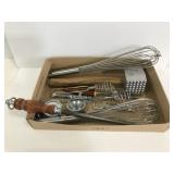 Lot of kitchen tools like whisks, meat tenderizer