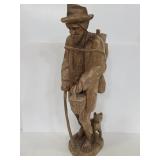 Large carved wood statue of traveling man & dog