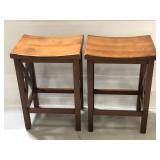 Two matching wooden bar saddle stools