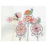Four painted pinwheel metal yard art stakes