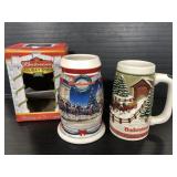 Two Budweiser holiday beer steins