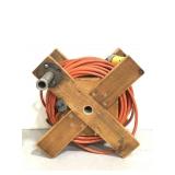 Extension cord on wooden reel